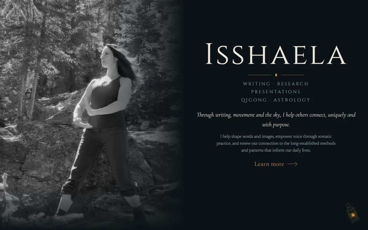 The isshaela.com home page on a laptop: her name in gold over a black and white photograph of her practising Qigong in a forest.