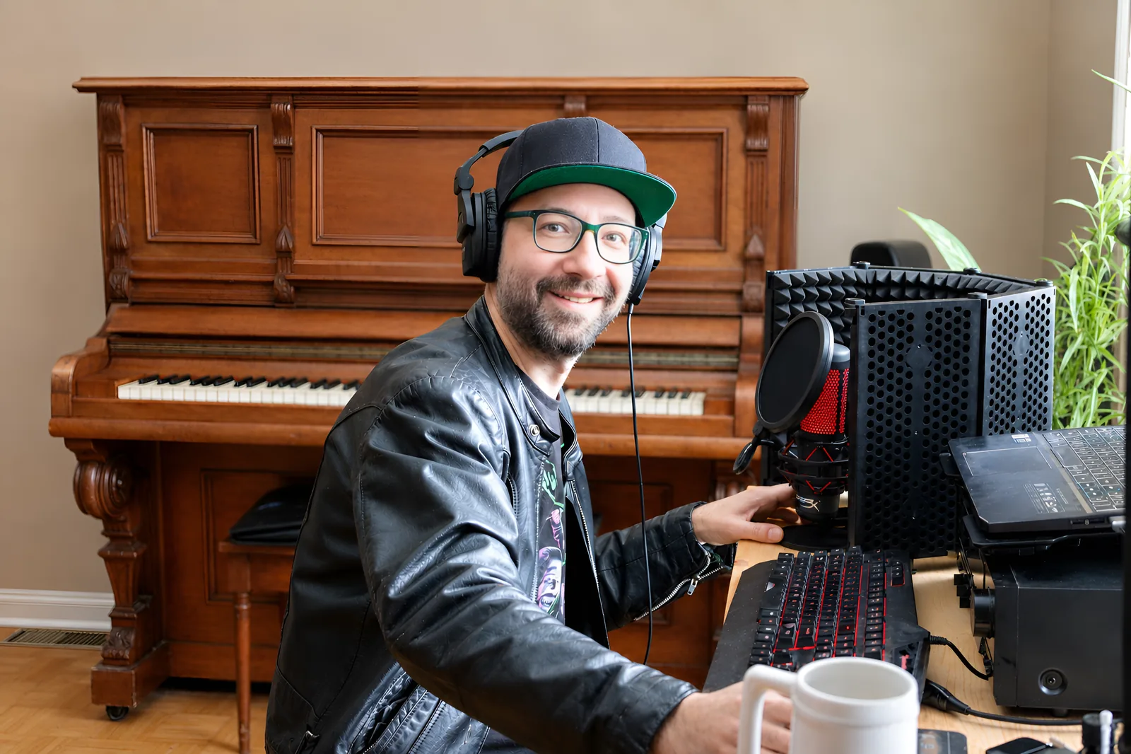 Mat Leger in his home studio, with his piano, microphone and keyboard